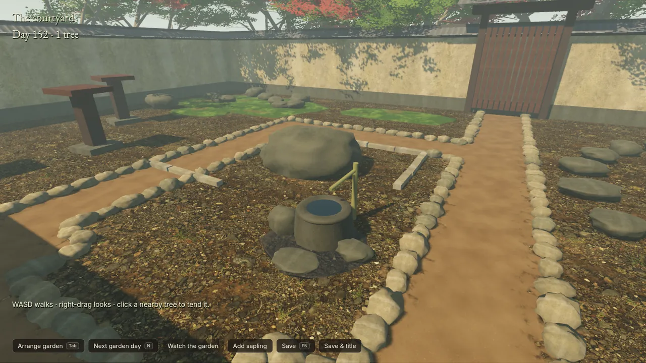 Development capture, 14 October: the courtyard's new water basin and large rock, beside paths edged with stones that each have their own shape, shown by the game itself.