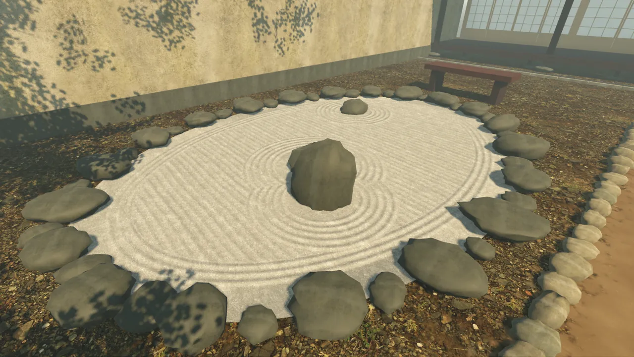 The dry pond from the path's far corner: raked lines across, three lines following the shore, rings round the standing stone and its companion.